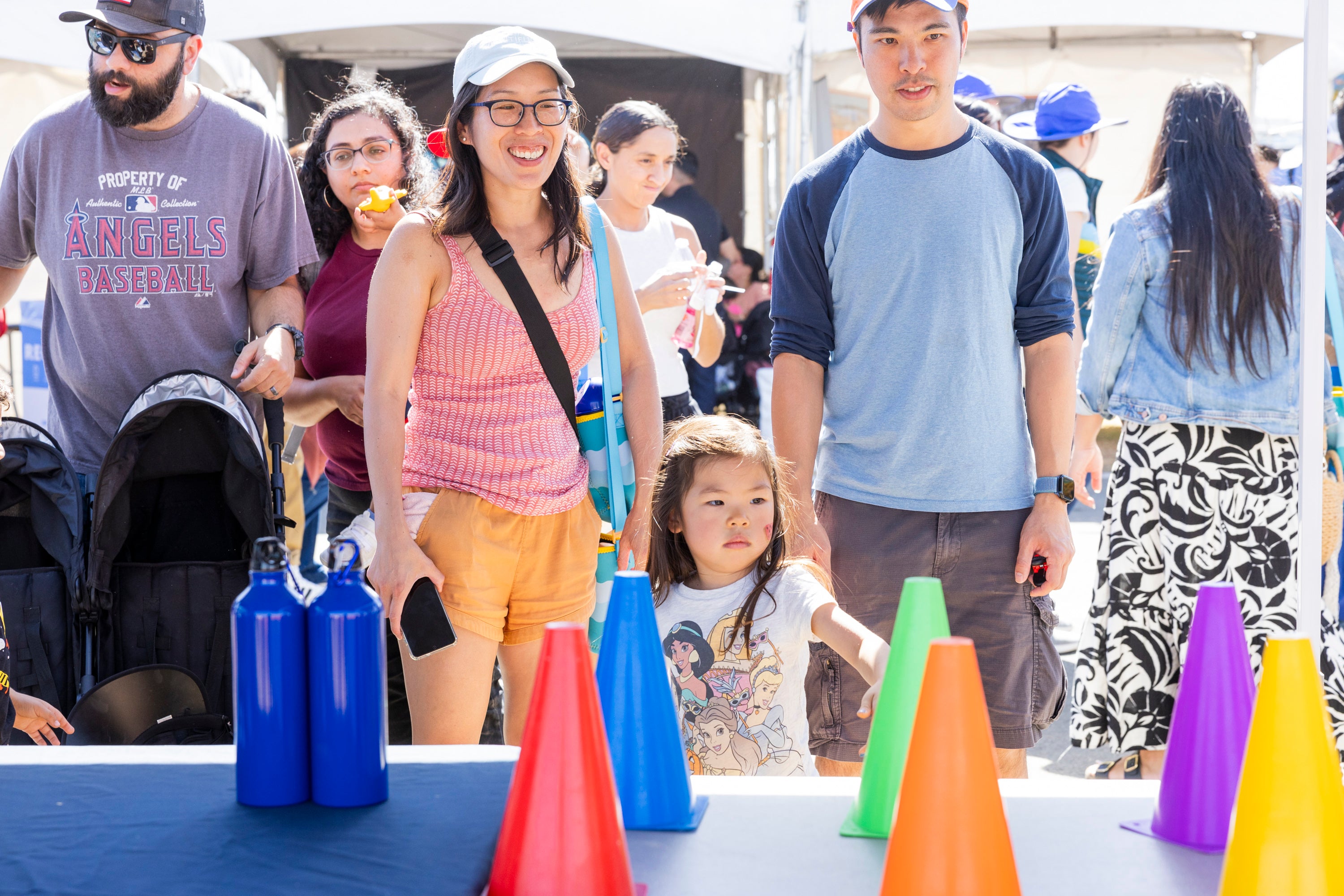 A family of three enjoying a carnival game. A family of three enjoying a carnival game.