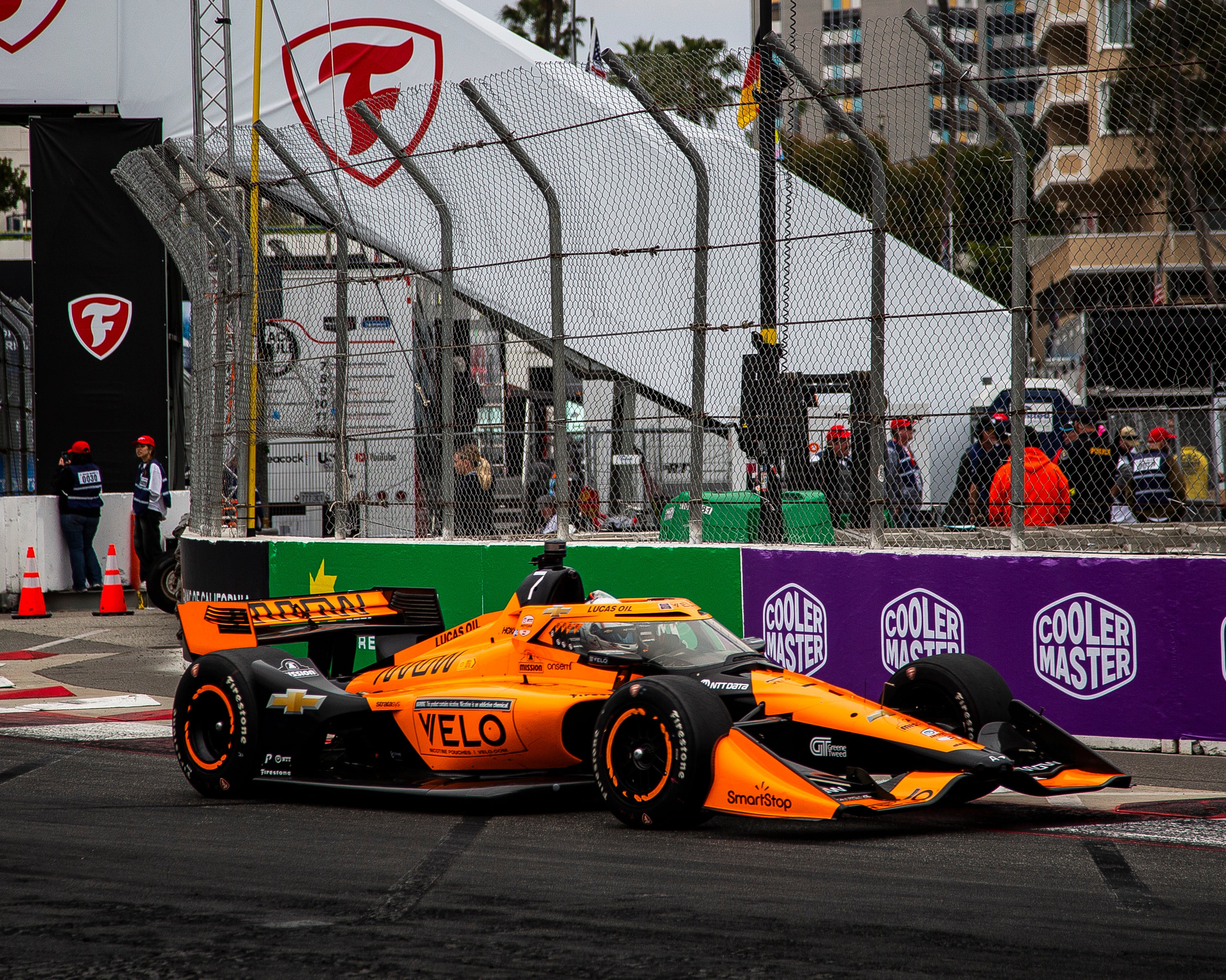 An orange racecar on the track An orange racecar on the track