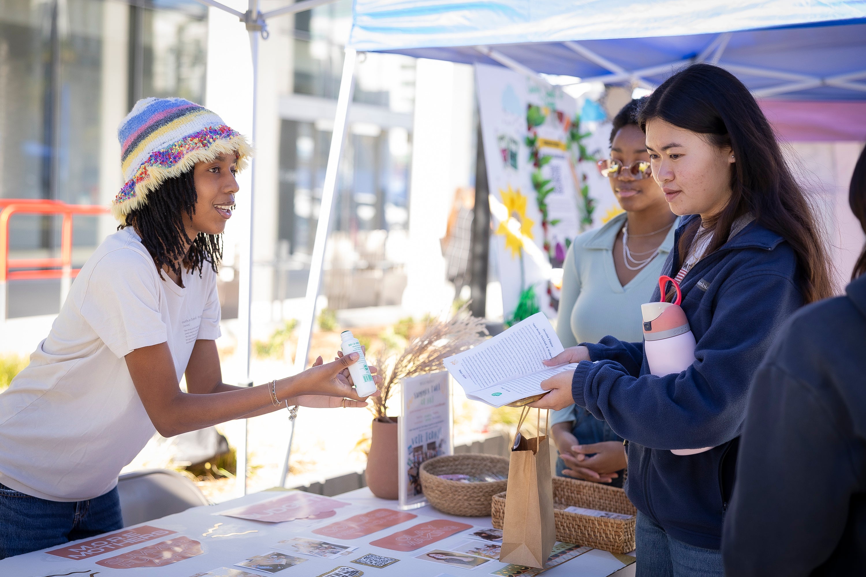 Two young women standing across a table Two young women standing across a table