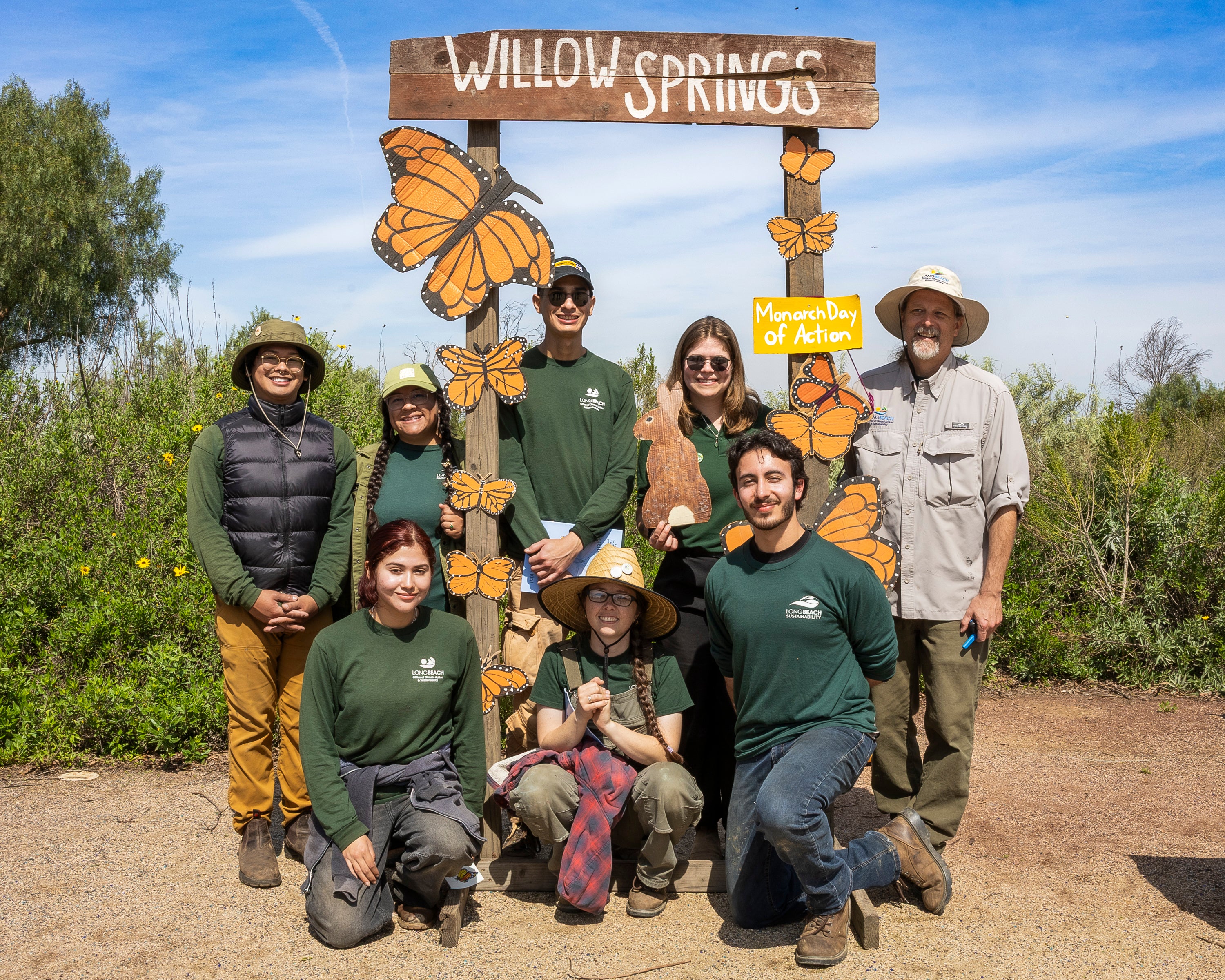 A group of volunteers posing in green shirts. A group of volunteers posing in green shirts.