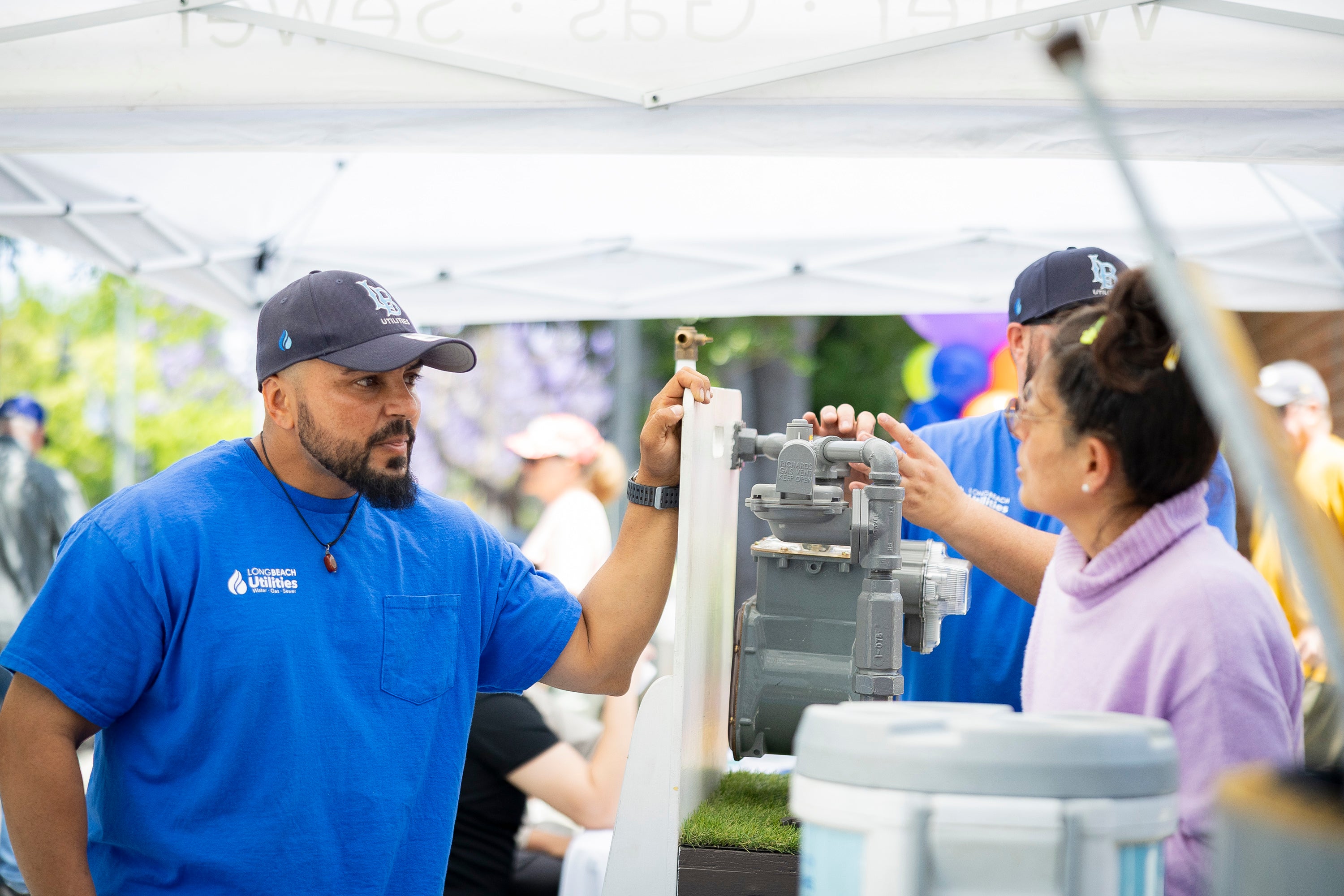 Utilities employee speaks with woman at Home Improvement Expo Utilities employee speaks with woman at Home Improvement Expo