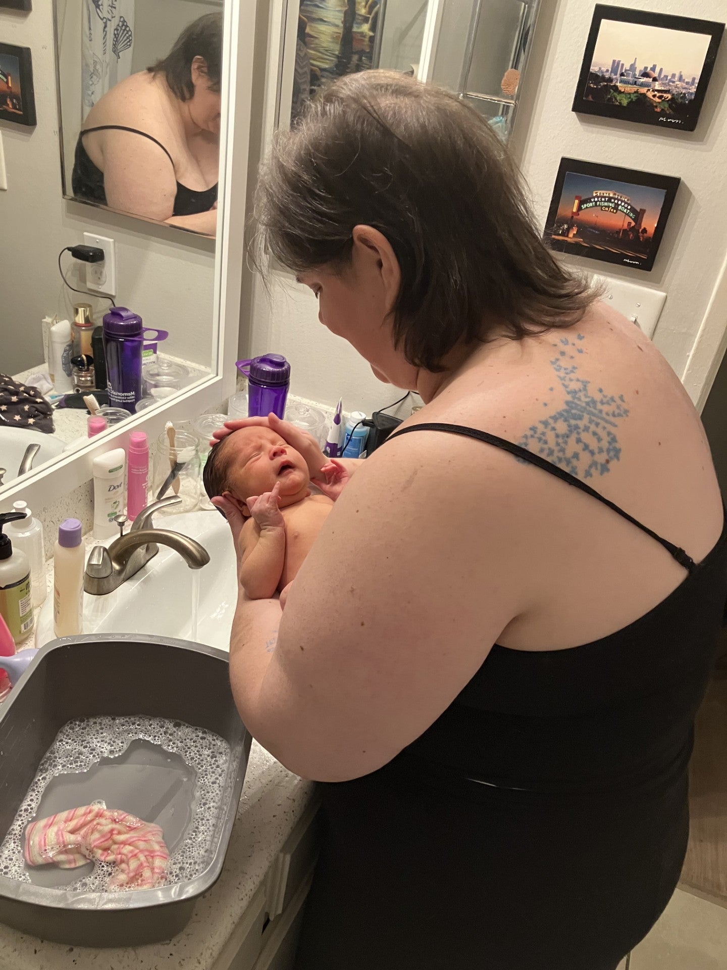 A woman holding a newborn baby 