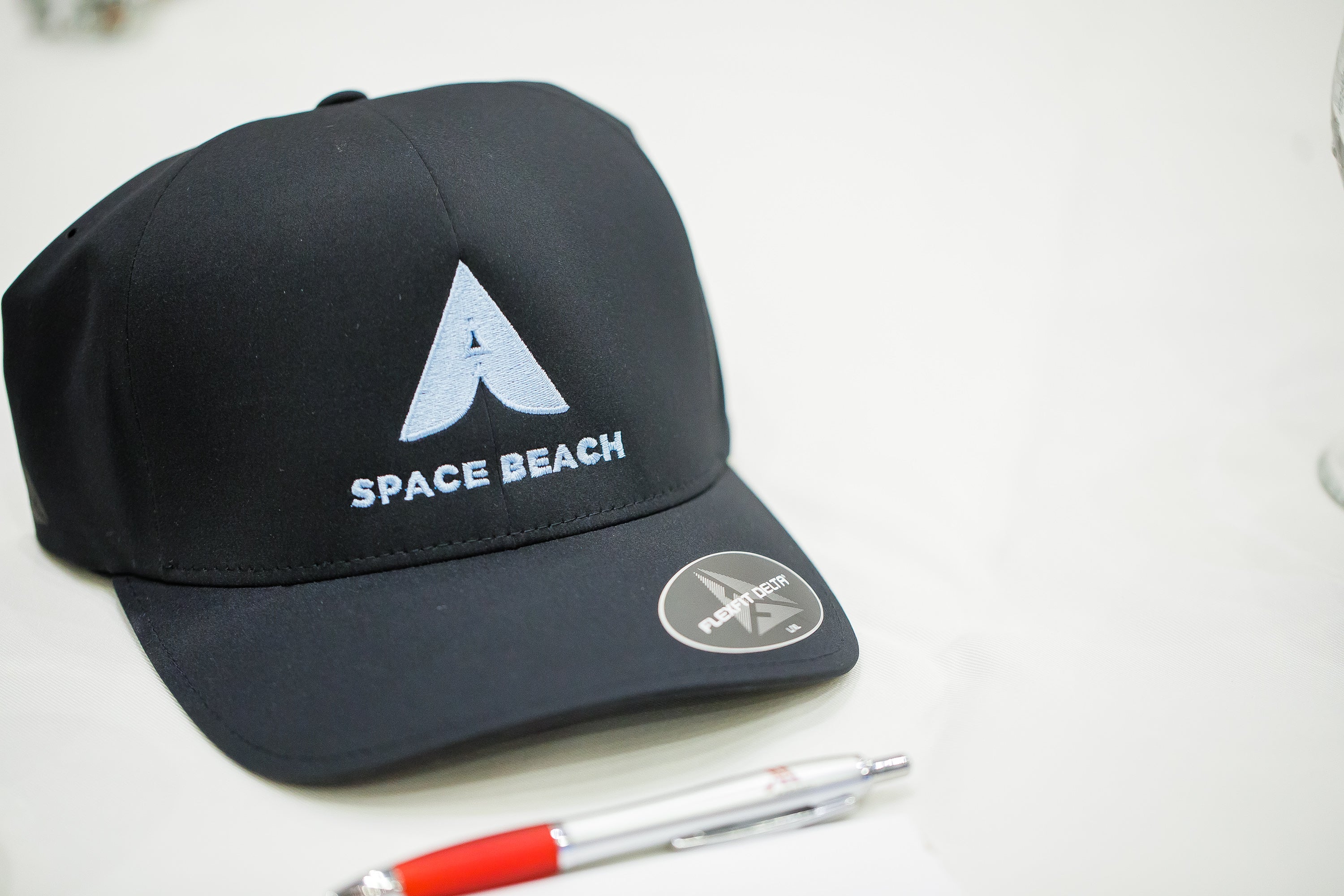 Black baseball cap on a table Black baseball cap on a table