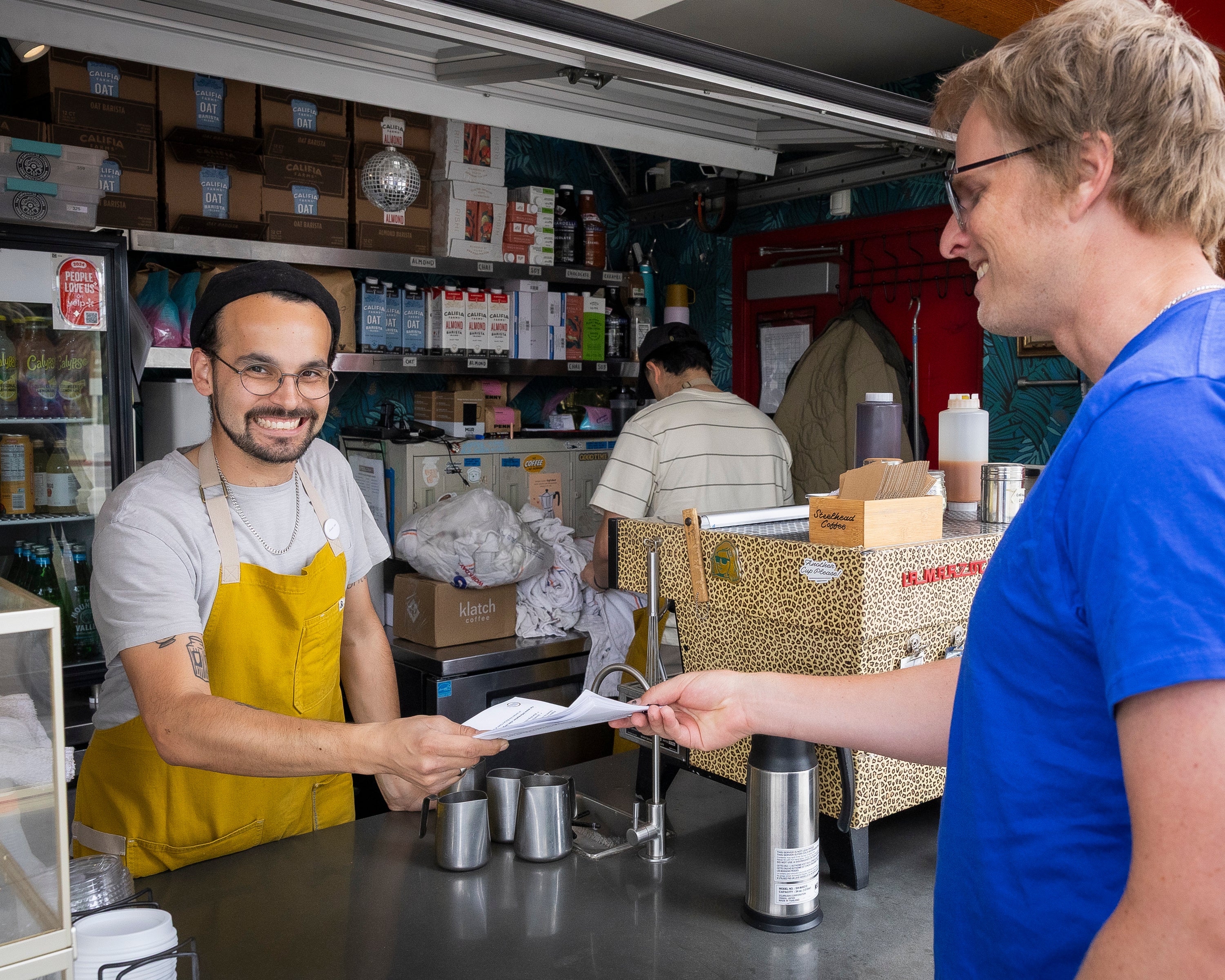 Cashier handing a man a receipt Cashier handing a man a receipt