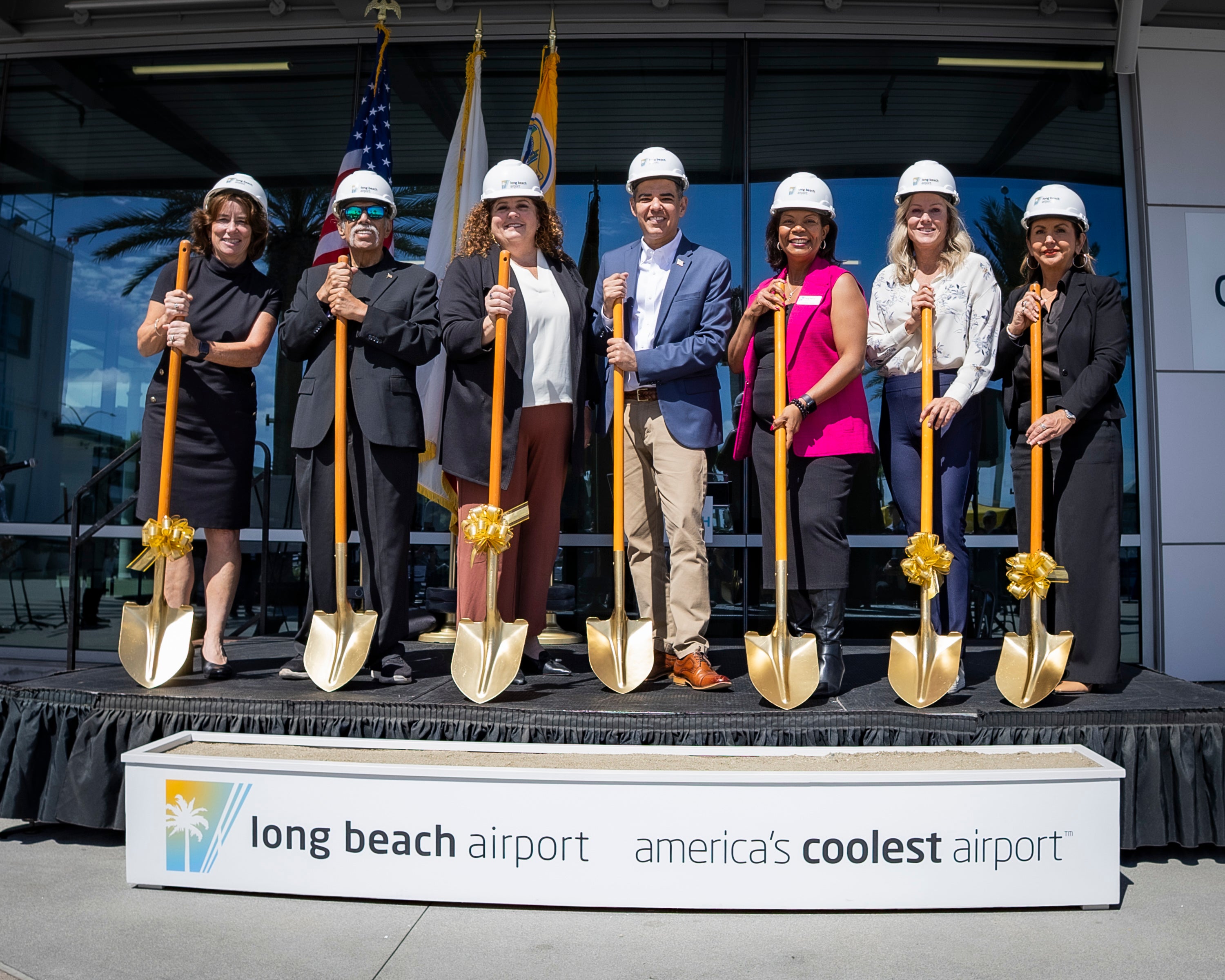City Council and Congressman Robert Garcia with Golden Shovels Standing on a Stage City Council and Congressman Robert Garcia with Golden Shovels Standing on a Stage