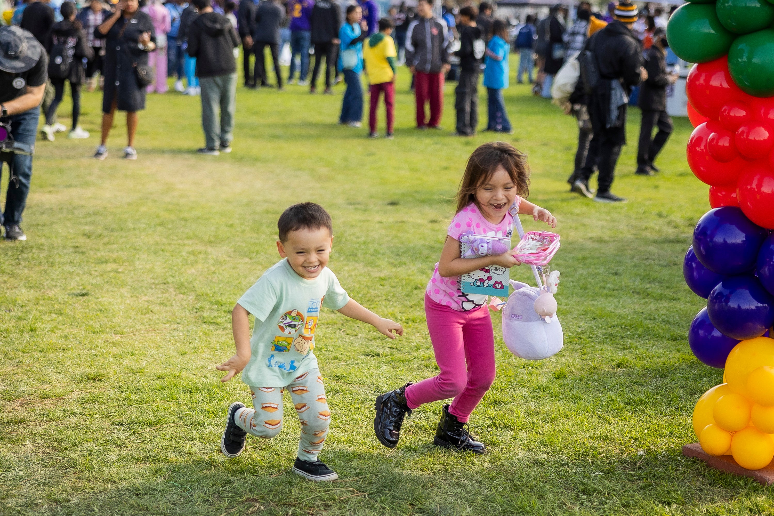 Two young children running a field. Two young children running a field.