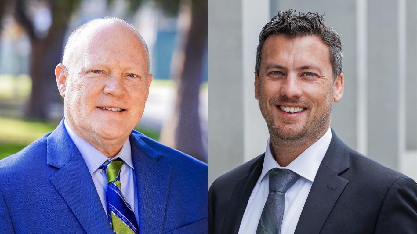 Headshot of two men in suits Headshot of two men in suits