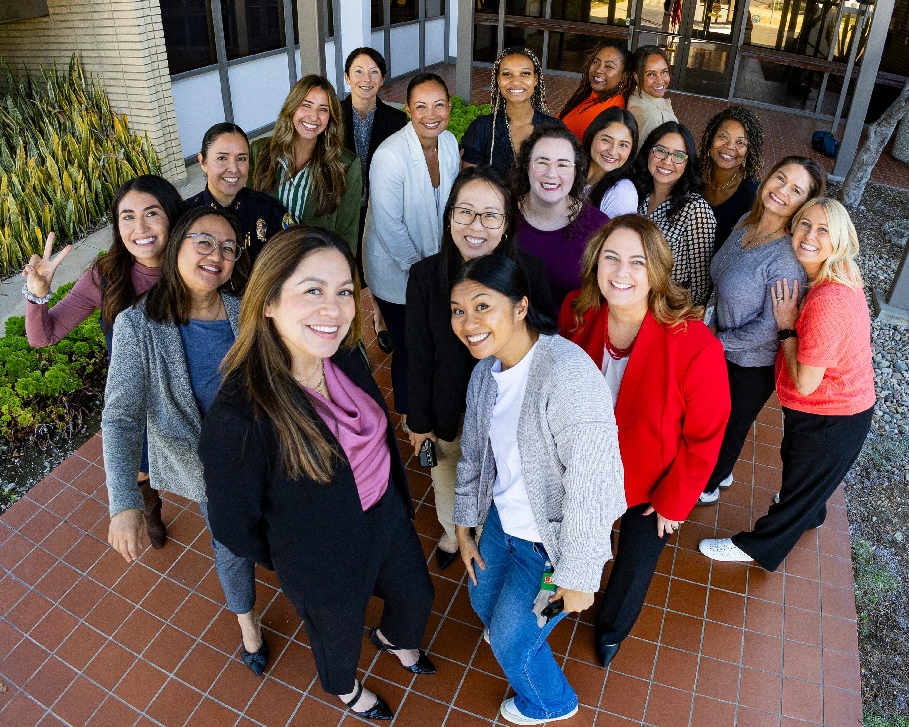 A group of women standing outside a building. 