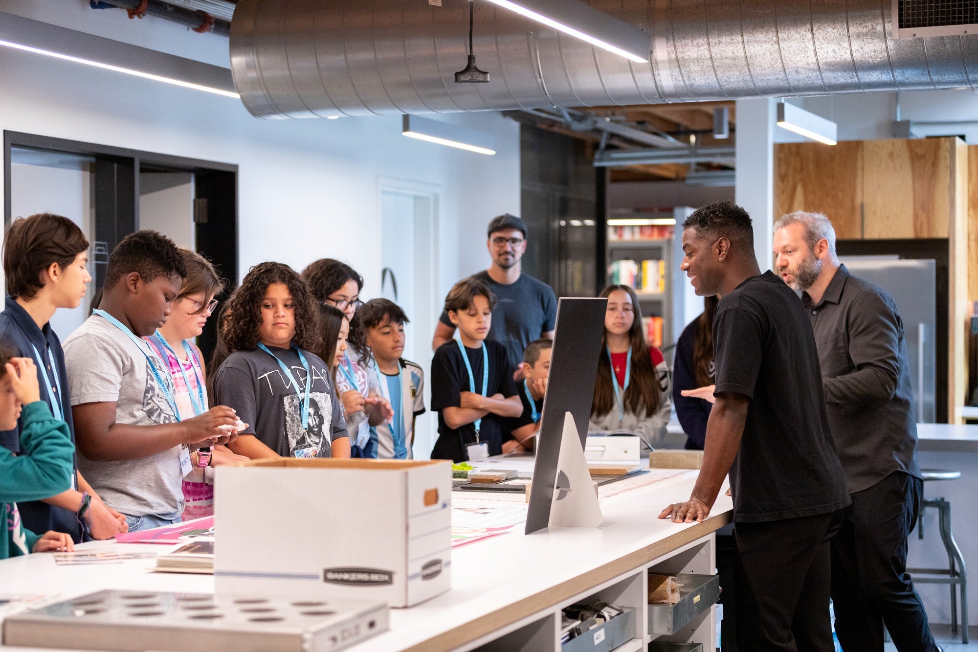 A group of kids gather around a table