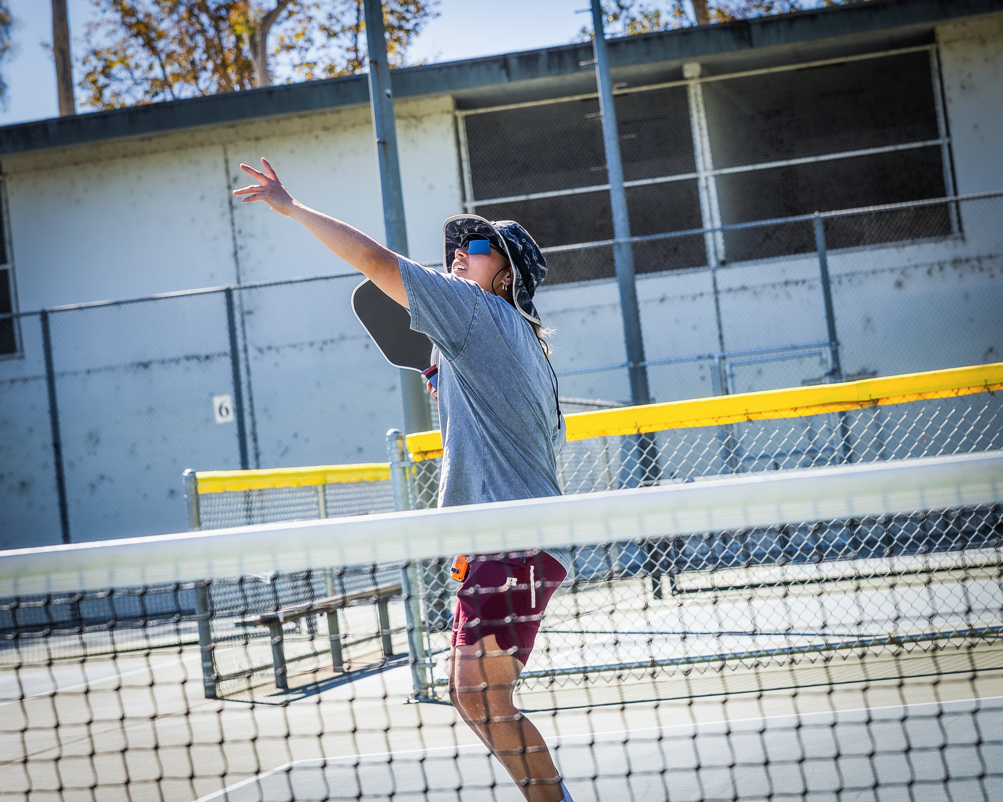 A man in a hat playing pickleball A man in a hat playing pickleball