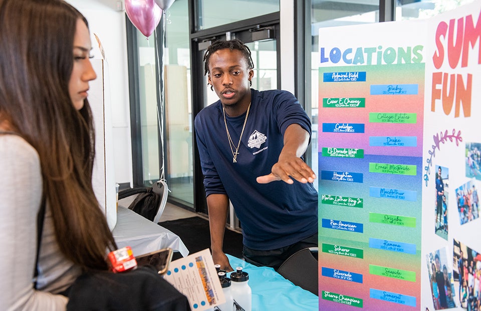 Man and woman looking at poster