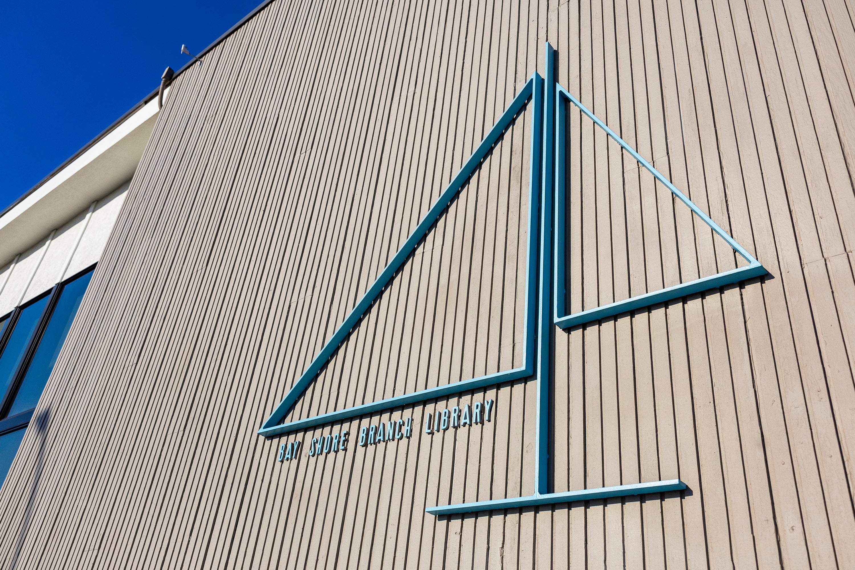 Logo in shape of a sail of the Bay Shore Branch Library. Logo in shape of a sail of the Bay Shore Branch Library.