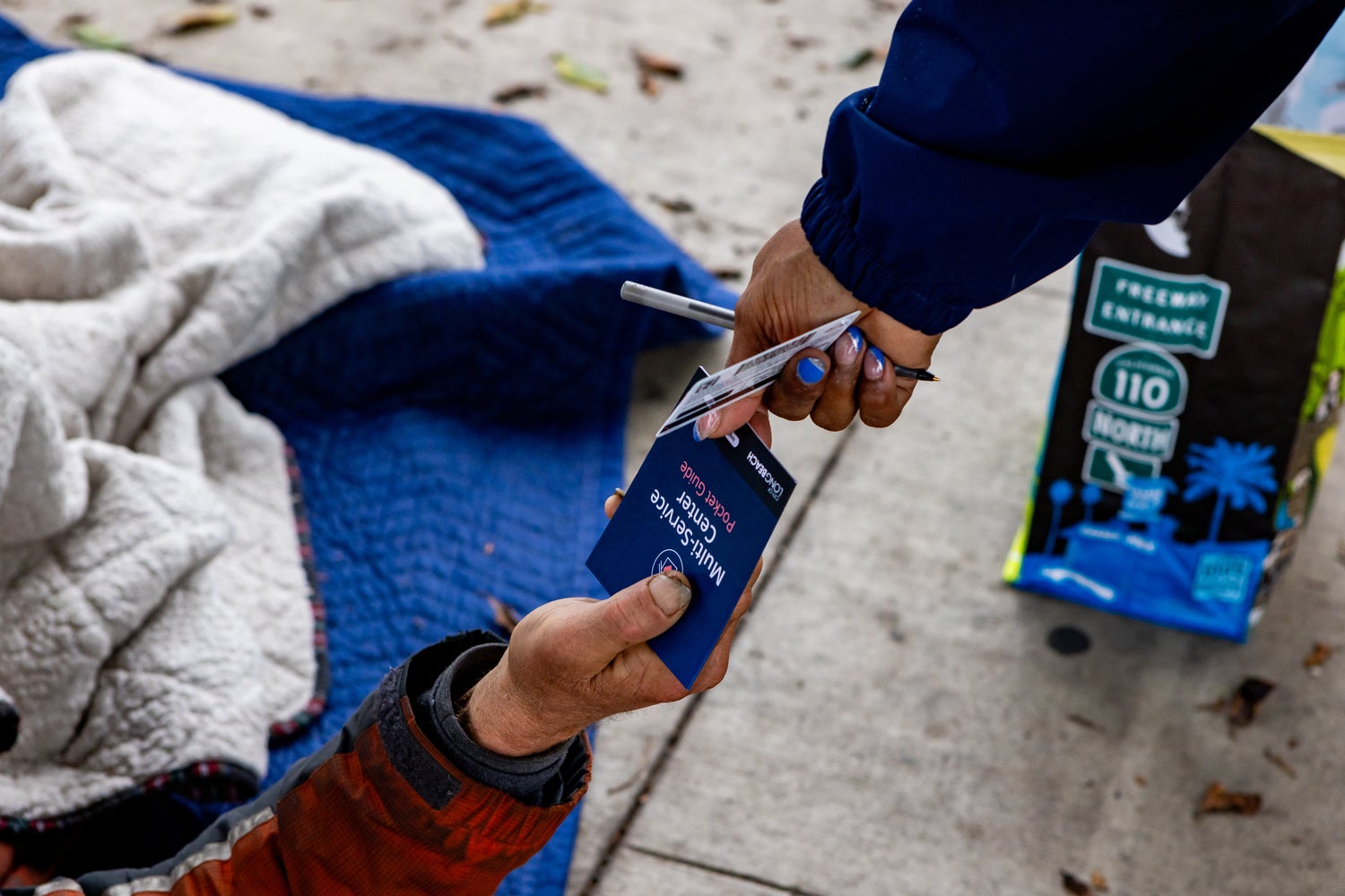 Homeless count volunteer passing out a Multi Service Center pamphlet. Homeless count volunteer passing out a Multi Service Center pamphlet.