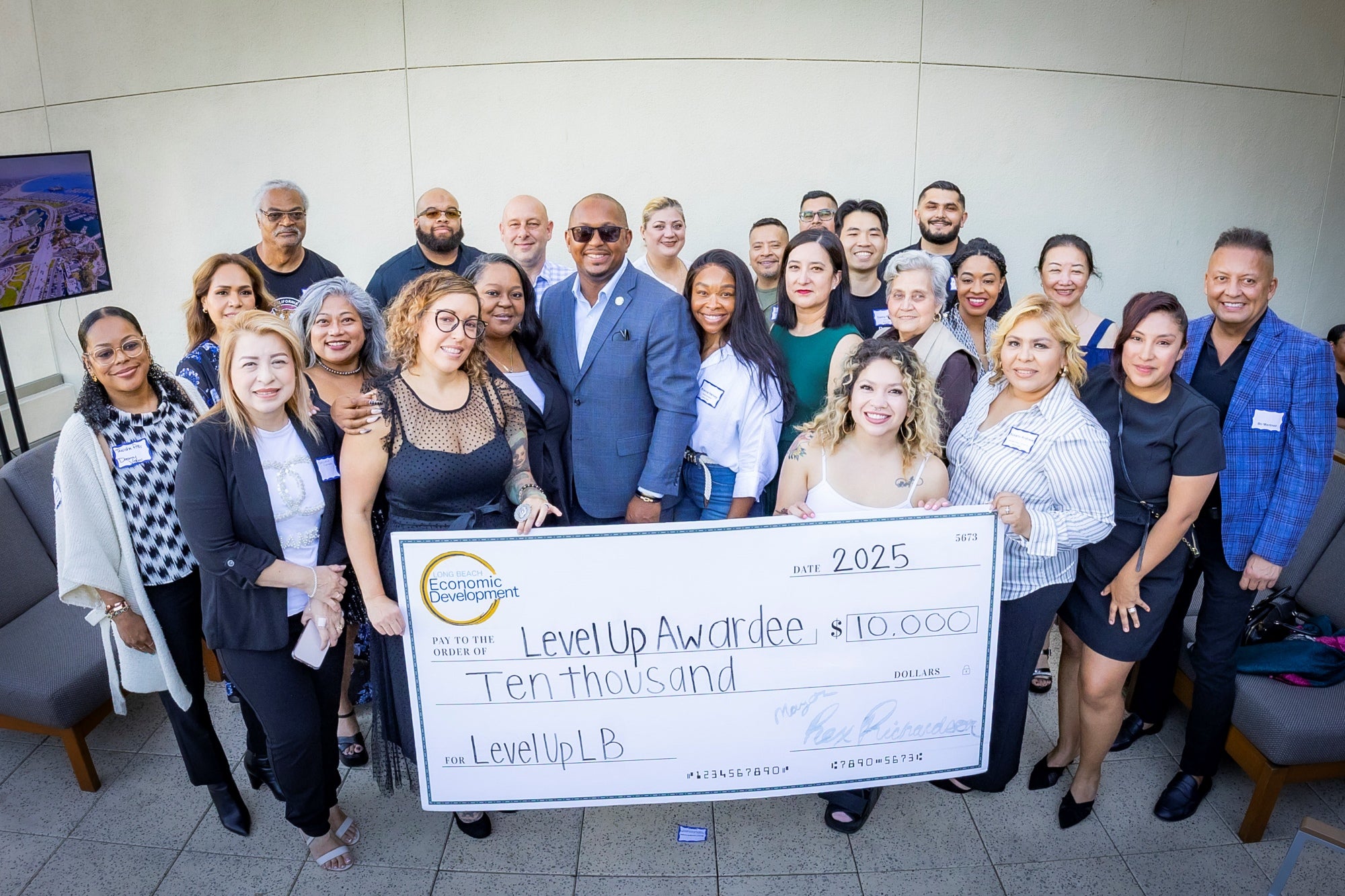 A group of people holding a giant check. A group of people holding a giant check.