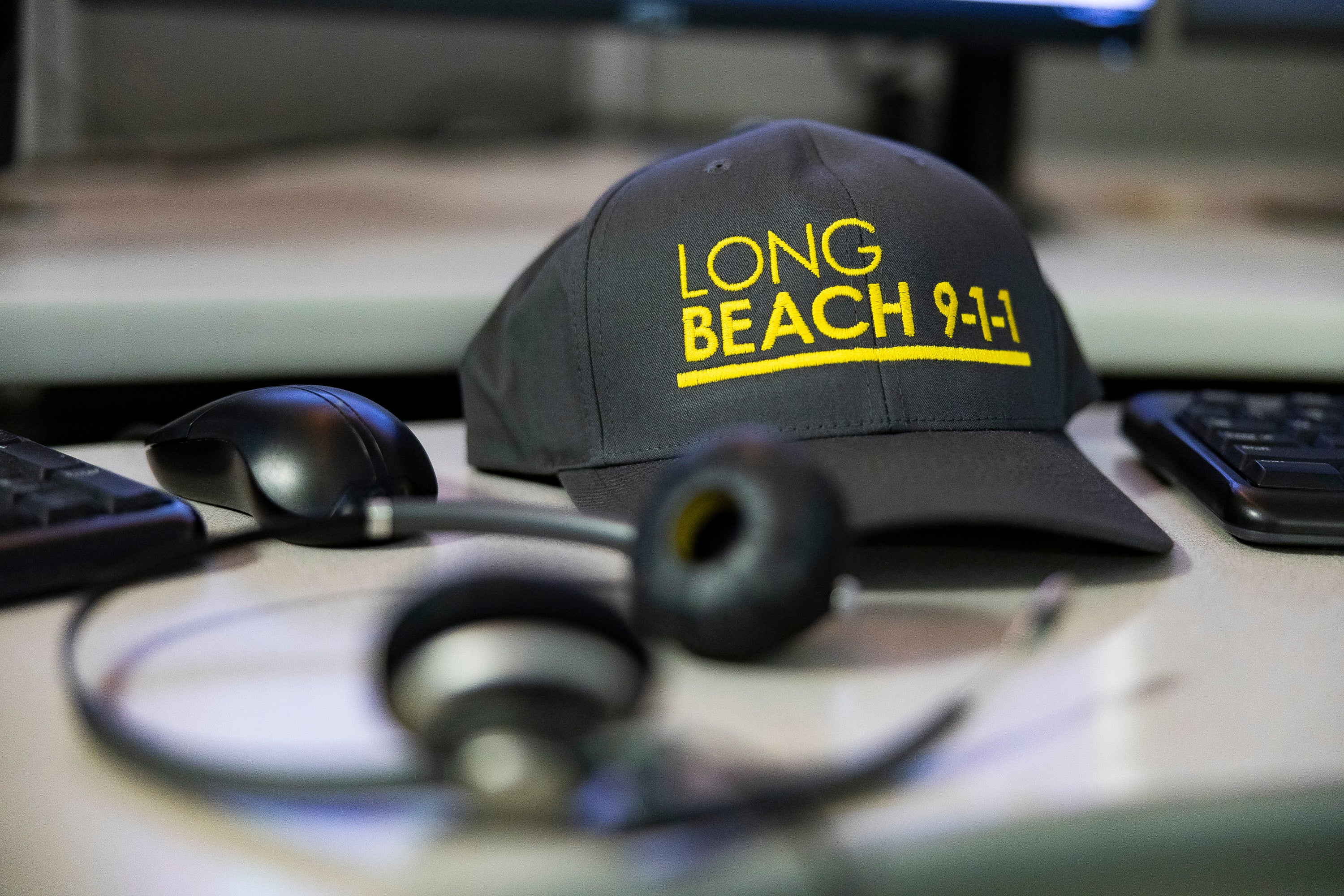 A headset and black hat on a desk. A headset and black hat on a desk.