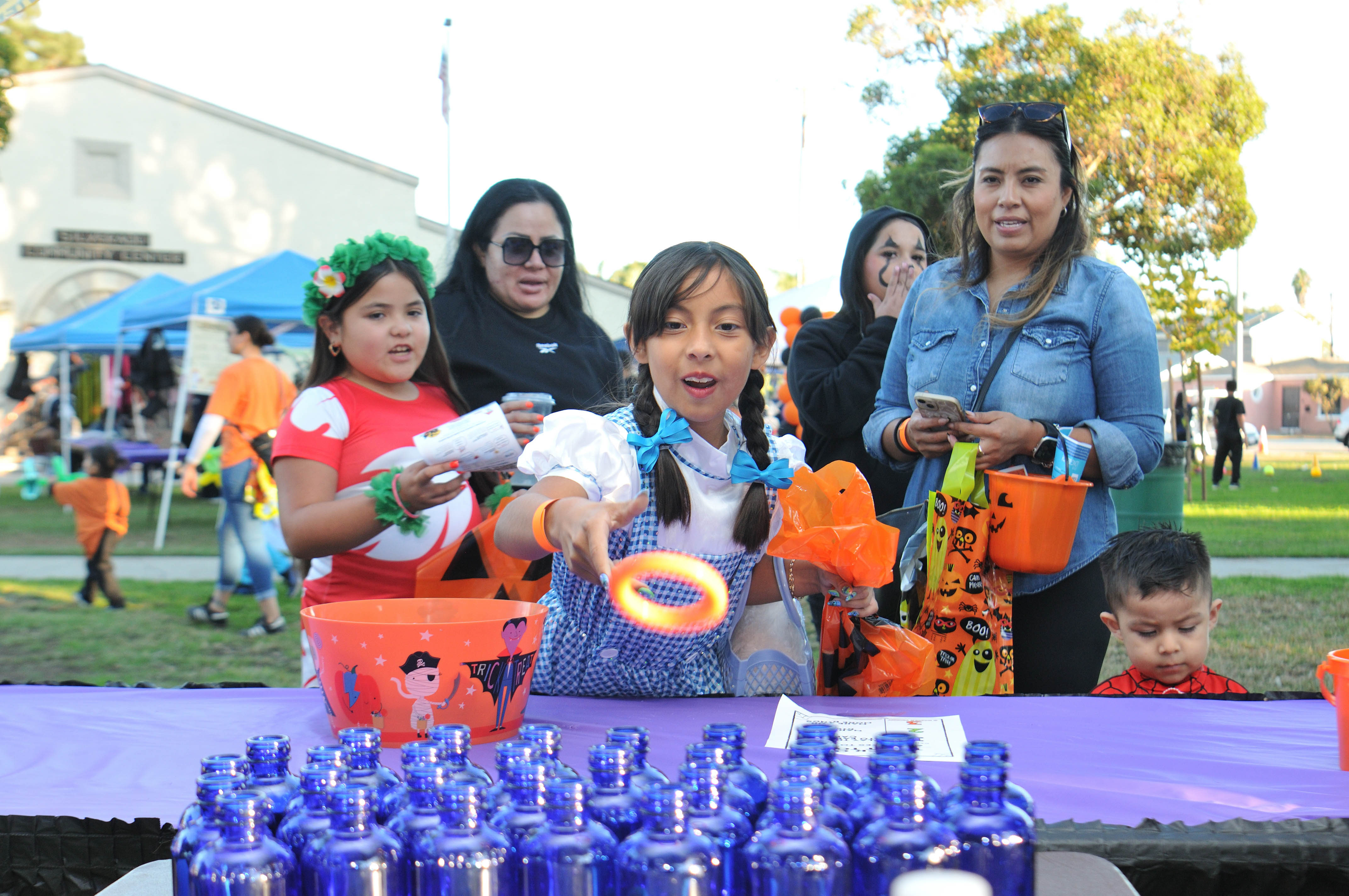 A little girl in a costume plays a carnival game.  A little girl in a costume plays a carnival game.