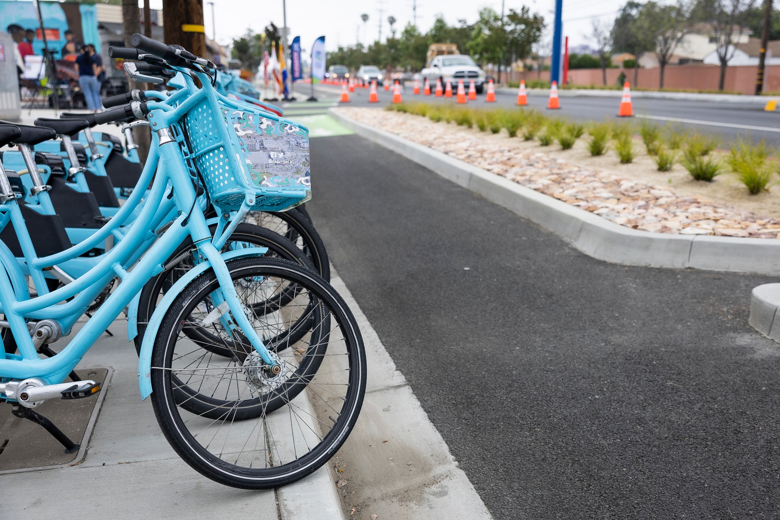 A row of blue bikes along the street A row of blue bikes along the street