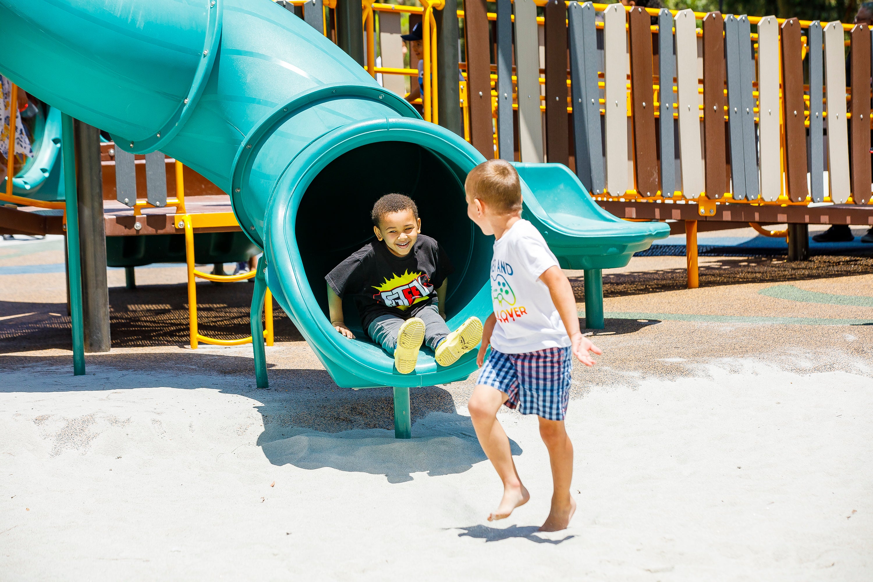 Two boys playing on a slide. Two boys playing on a slide.