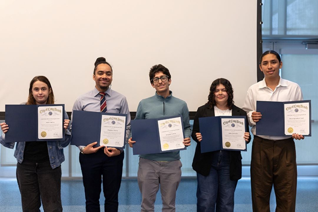 Row of teenagers holding certificates 