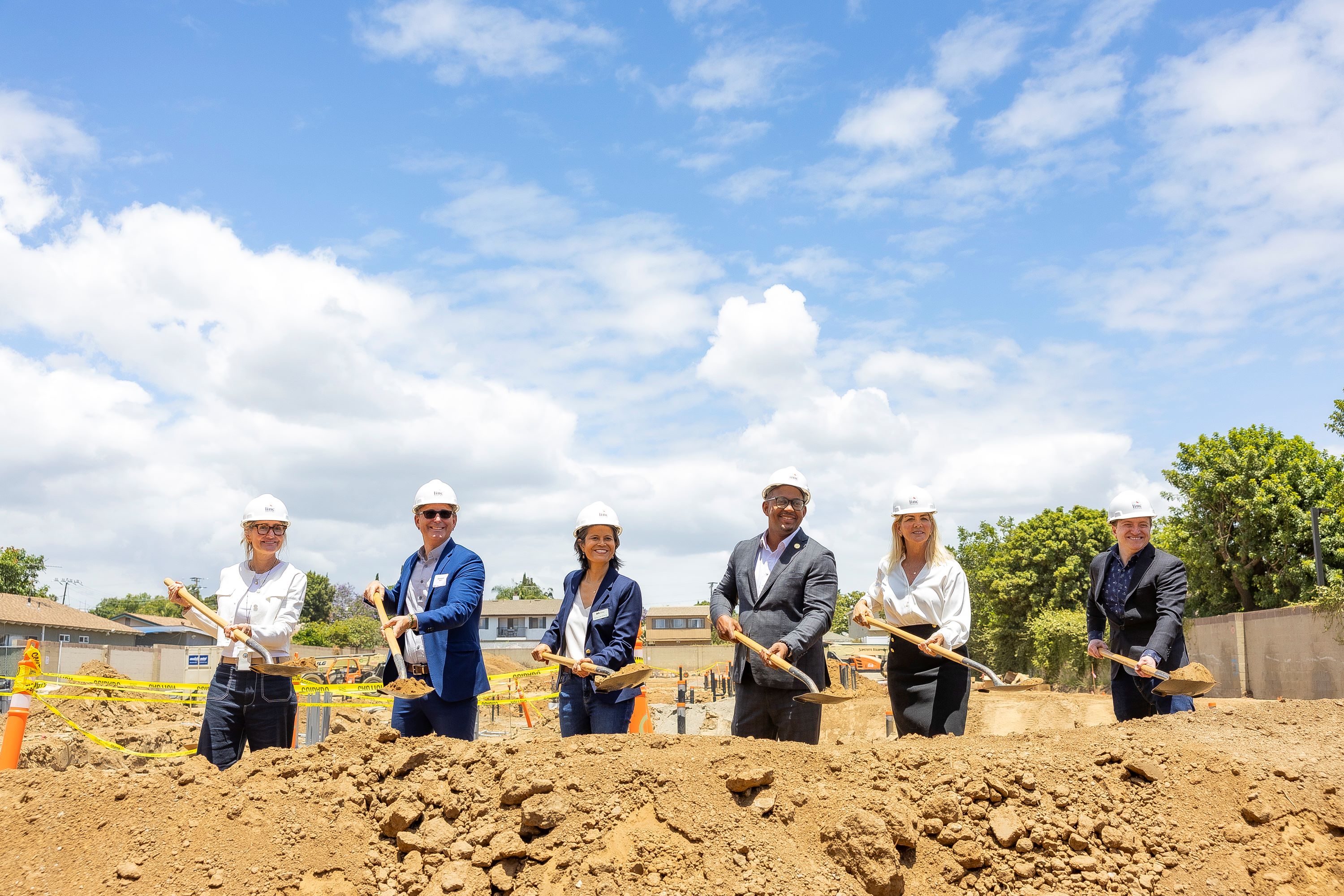 A group of people with shovels at a groundbreaking A group of people with shovels at a groundbreaking