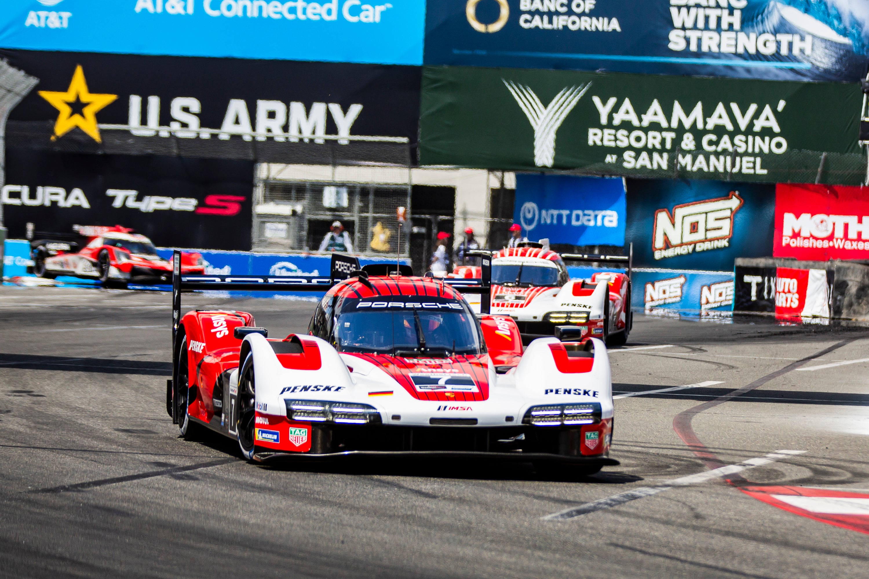 Red and white racing cars driving on a track. Red and white racing cars driving on a track.