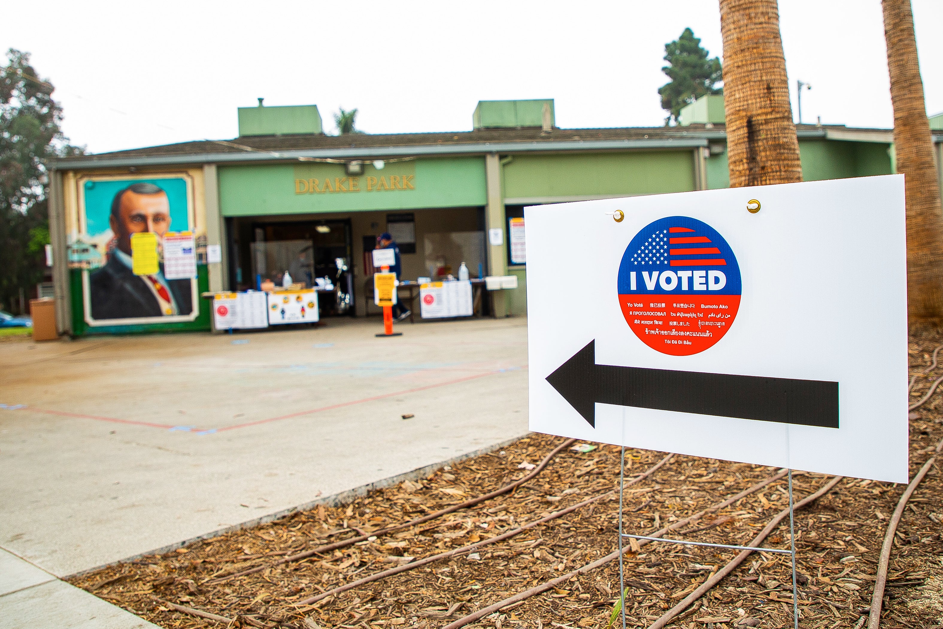 White "Vote" sign outside of green building White "Vote" sign outside of green building