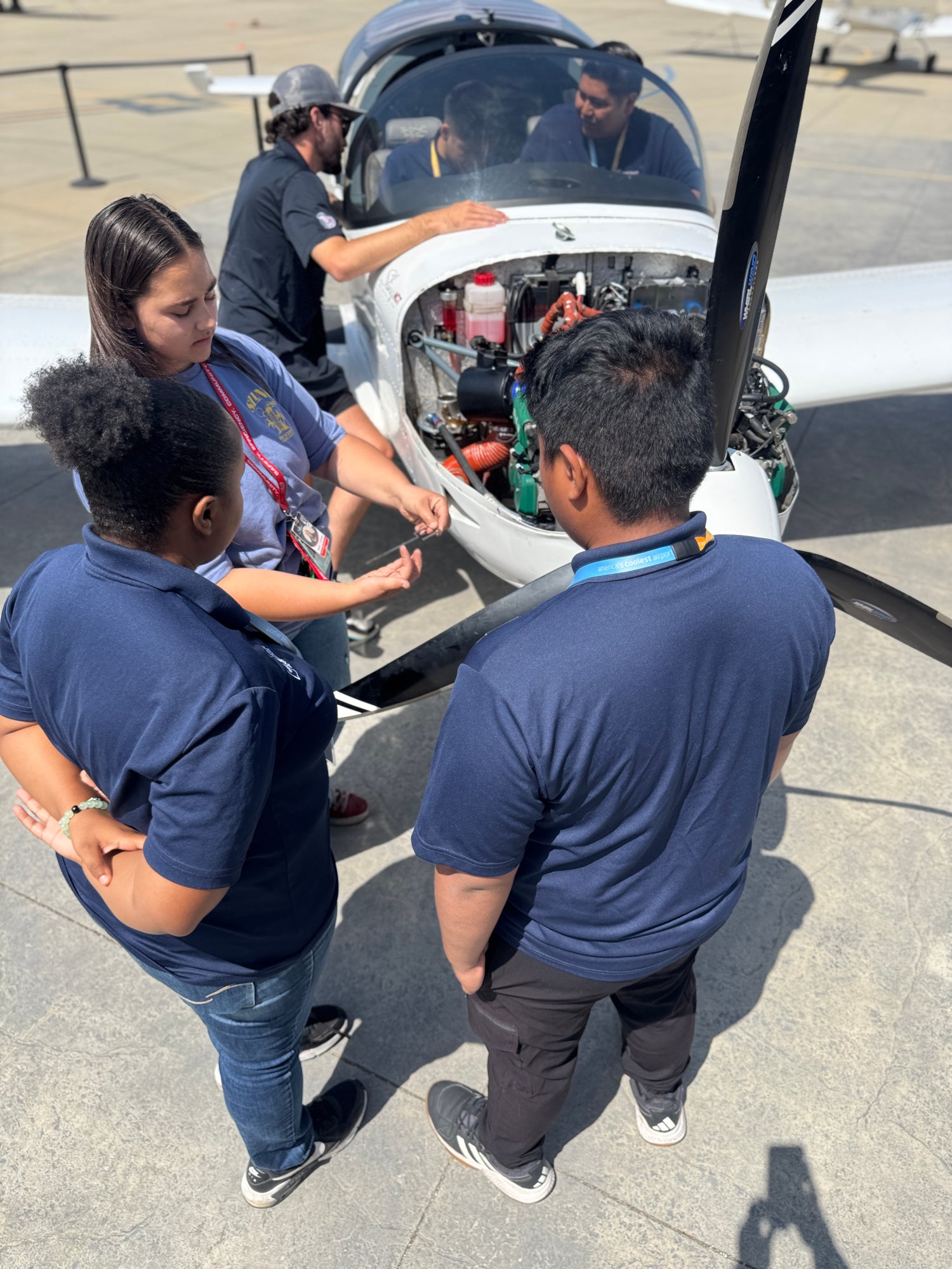 Students from Cabrillo and Jordan high schools maintaining a single engine plane.
