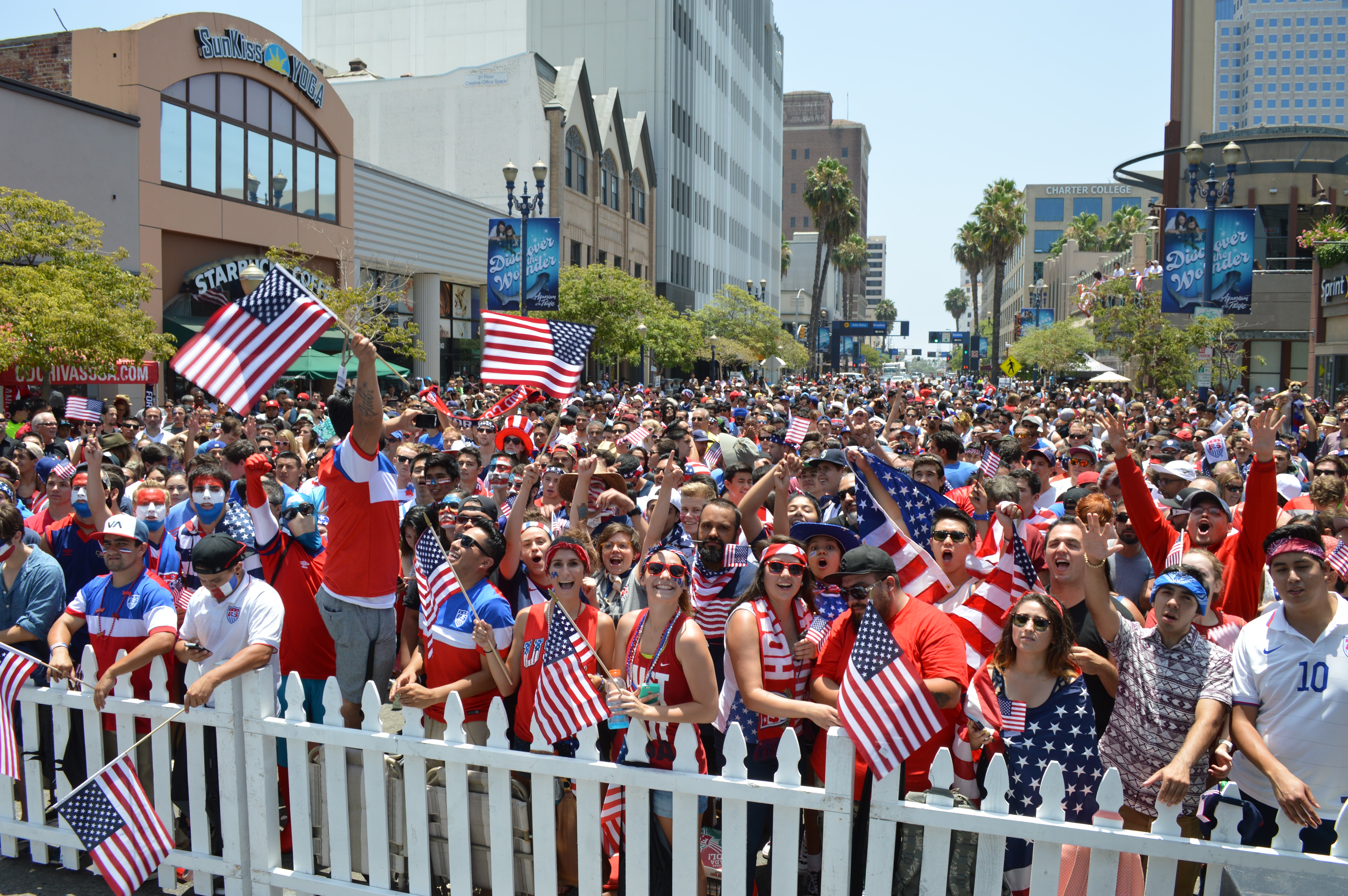 A crowd of people waving American flags A crowd of people waving American flags