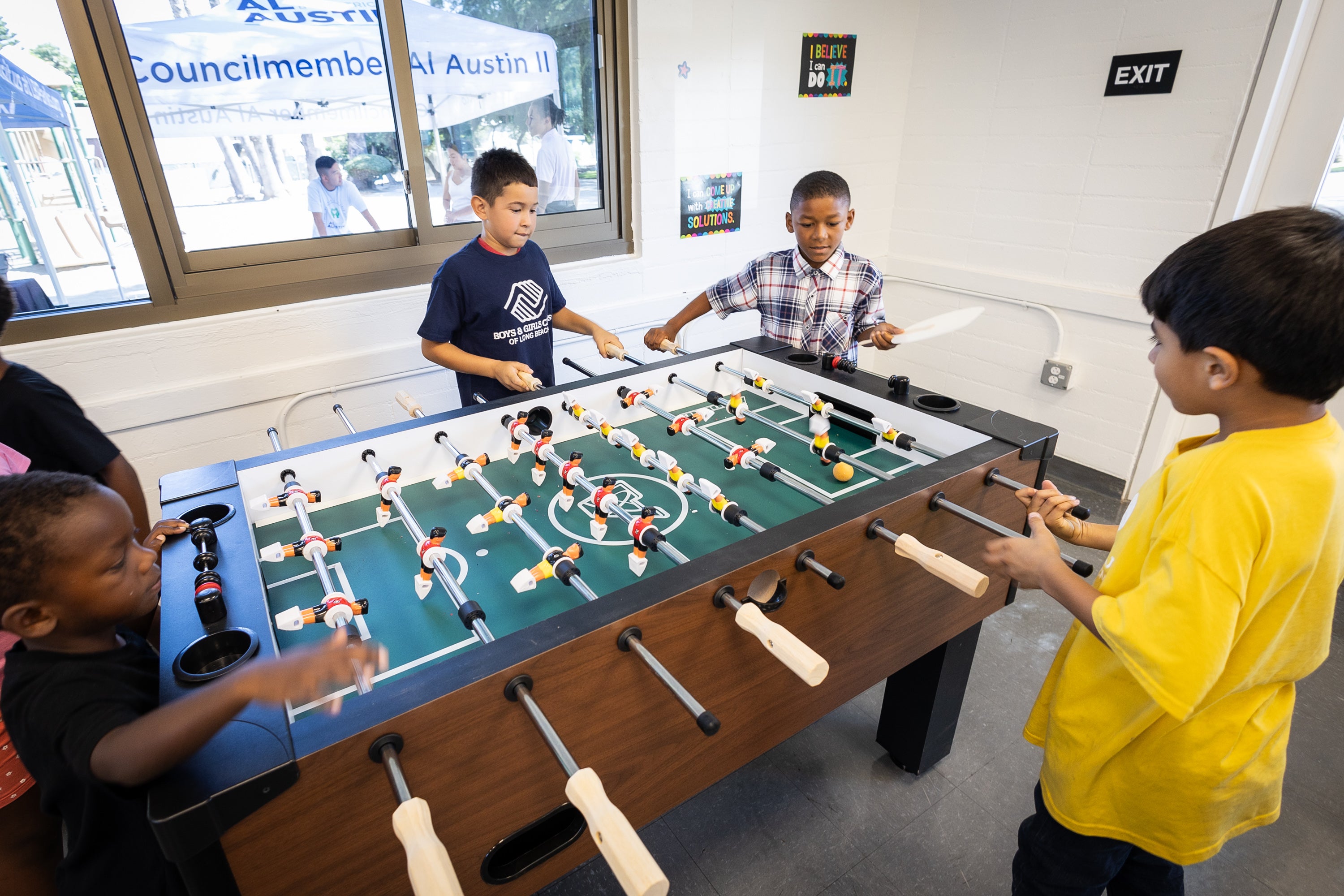 Group of young boys playing foosball Group of young boys playing foosball