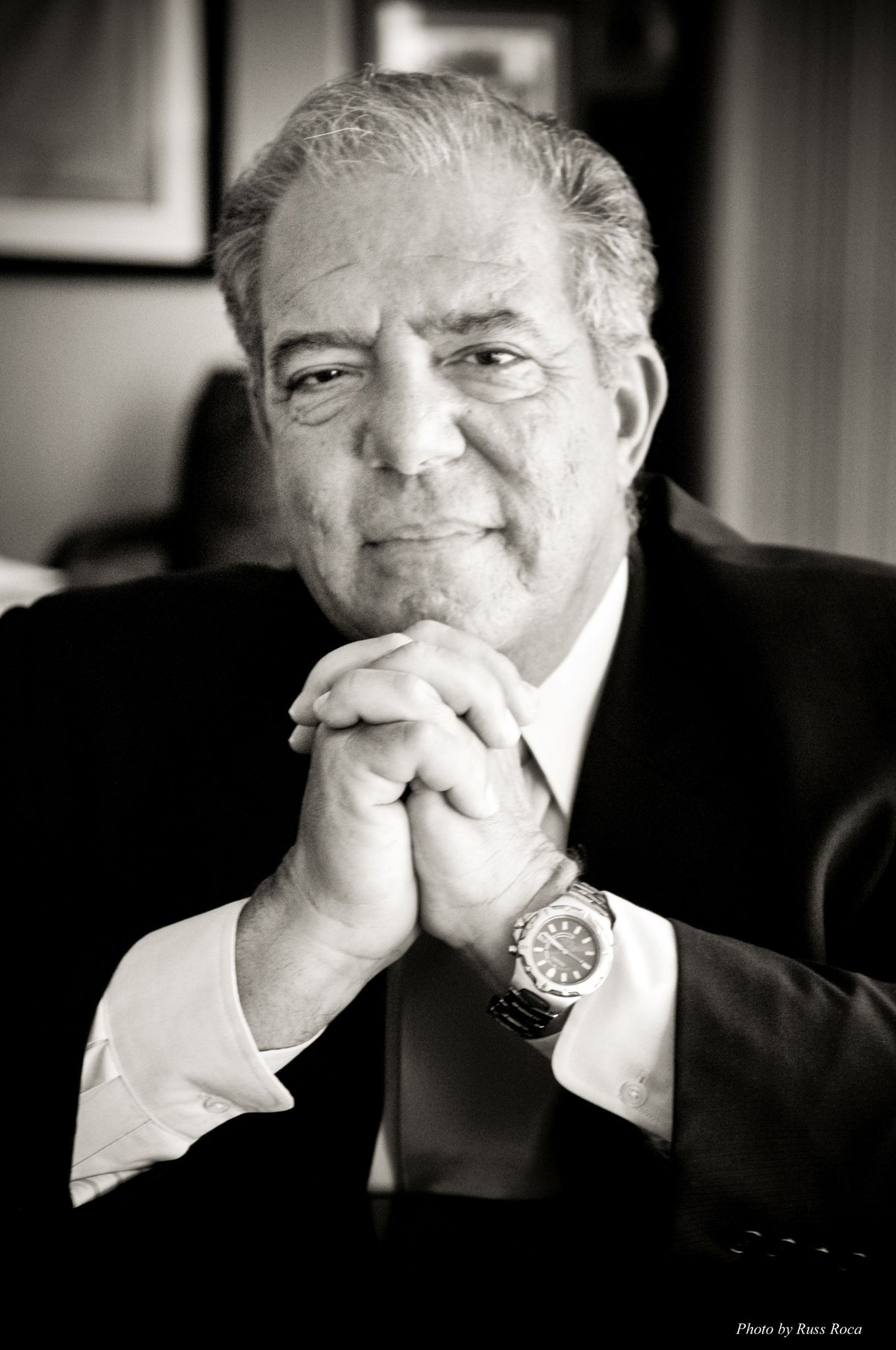 A headshot of an older man wearing a suit 