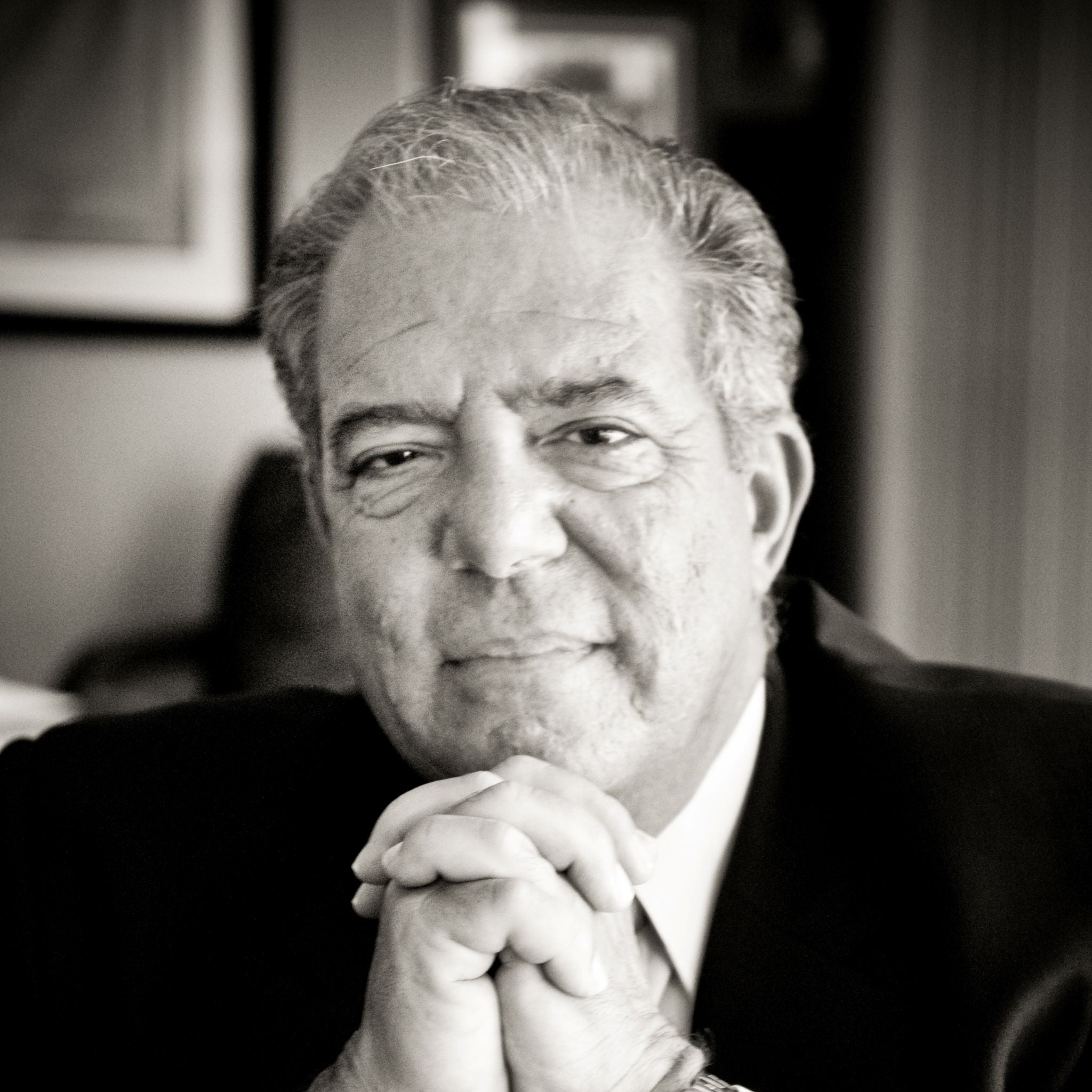 A headshot of an older man wearing a suit A headshot of an older man wearing a suit